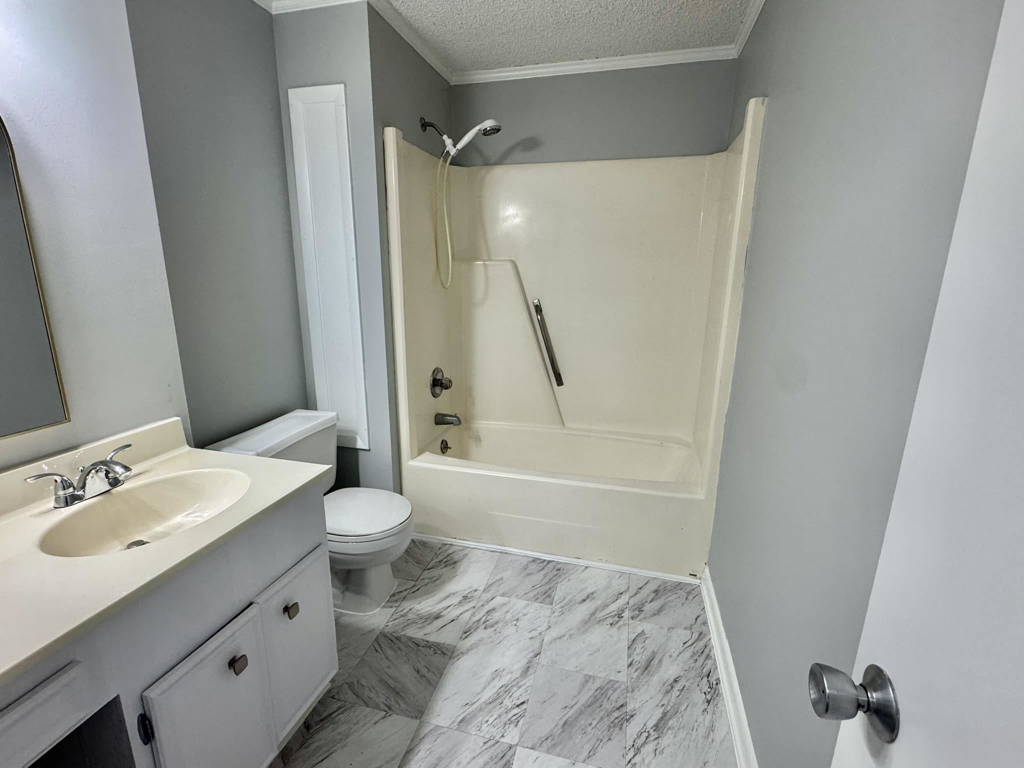 4115 Little River Road, Unit 10B Myrtle Beach, SC 29577 - Photo 27 of 31 Full bathroom featuring vanity, shower / bath combination, a textured ceiling, crown molding, and light marble finish flooring