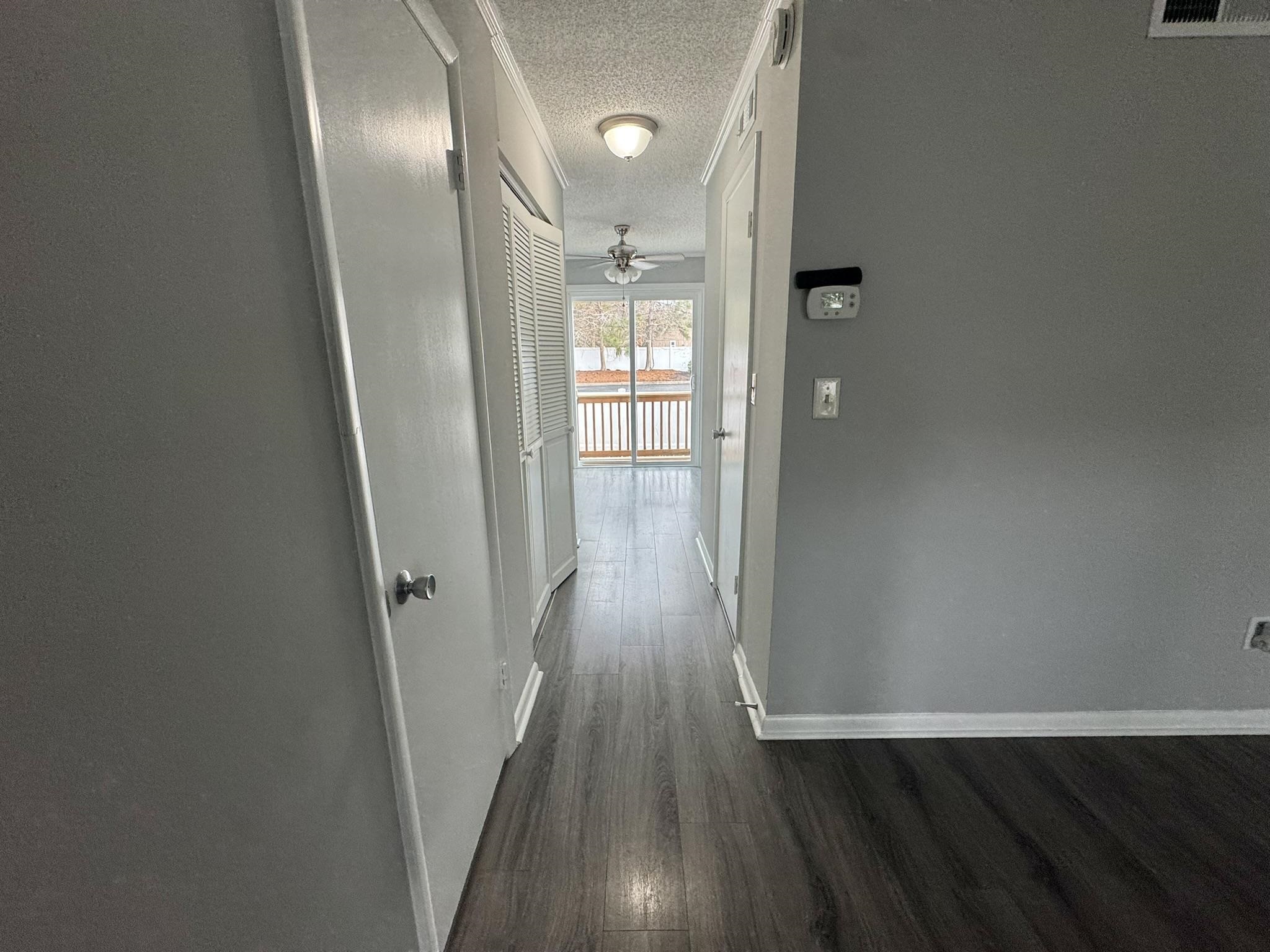 4115 Little River Road, Unit 10B Myrtle Beach, SC 29577 - Photo 5 of 31 Corridor with a textured ceiling and dark wood-style floors