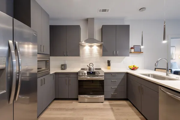 a close view of a sink a counter and a stove