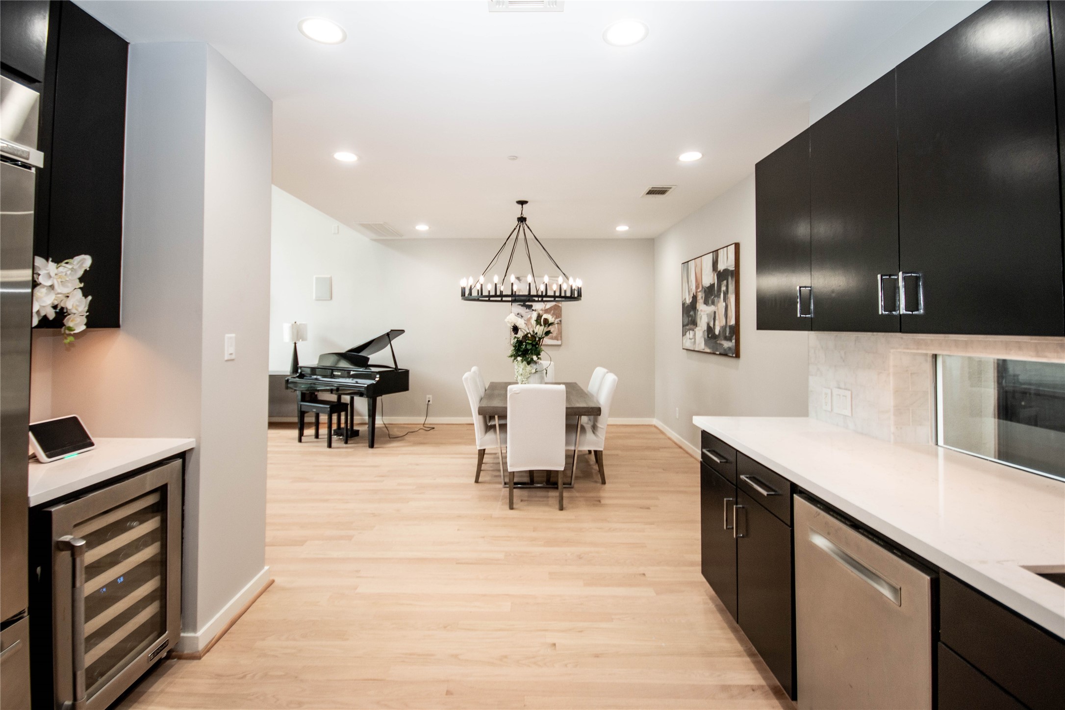 2423 West Main Street, Unit B Houston, TX 77098 - Photo 9 of 45 a room with stainless steel appliances kitchen island a white cabinets and chandelier