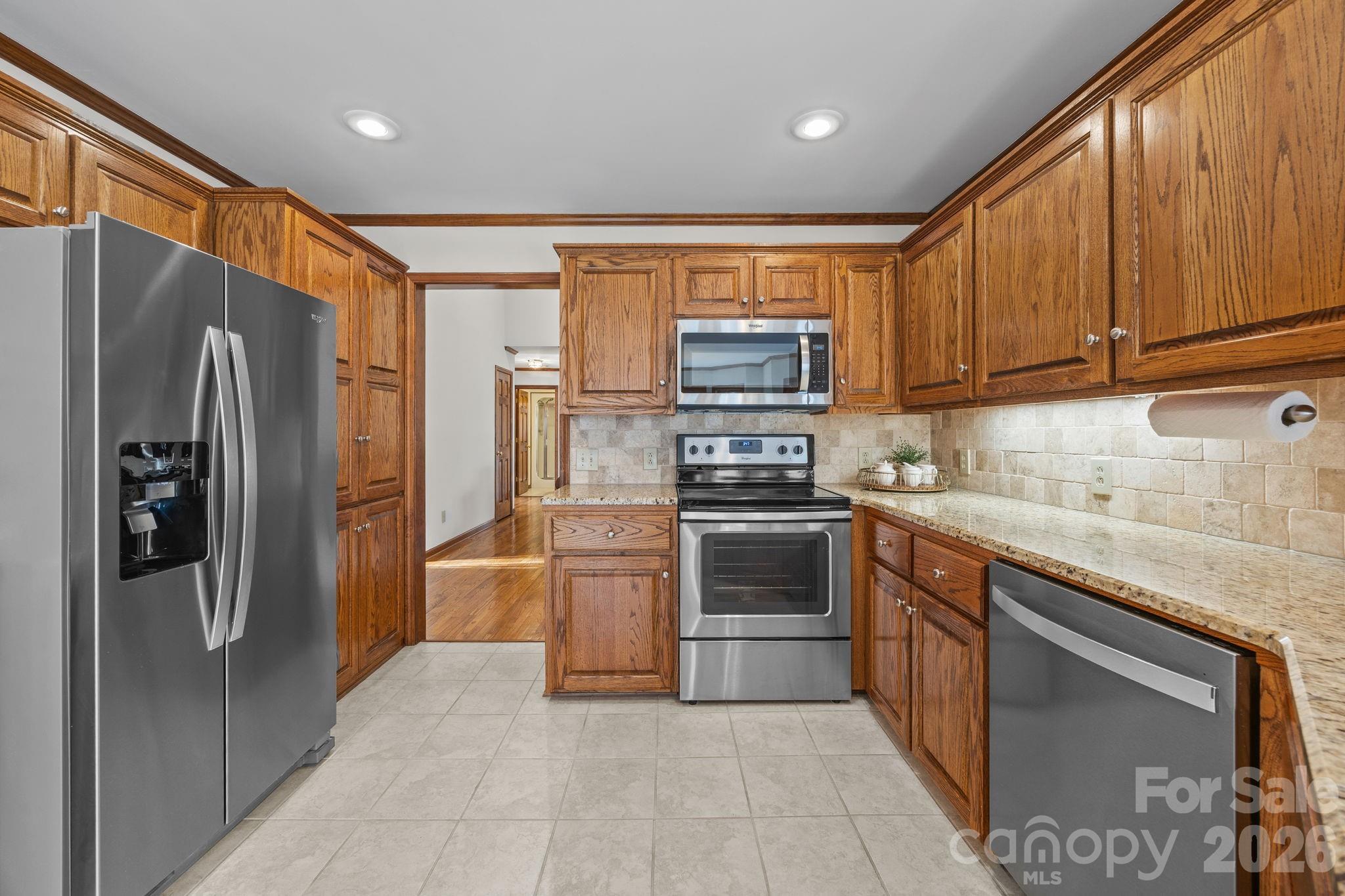 49449 River Run Road Albemarle, NC 28001 - Photo 12 of 45 a kitchen with stainless steel appliances granite countertop a refrigerator stove and oven