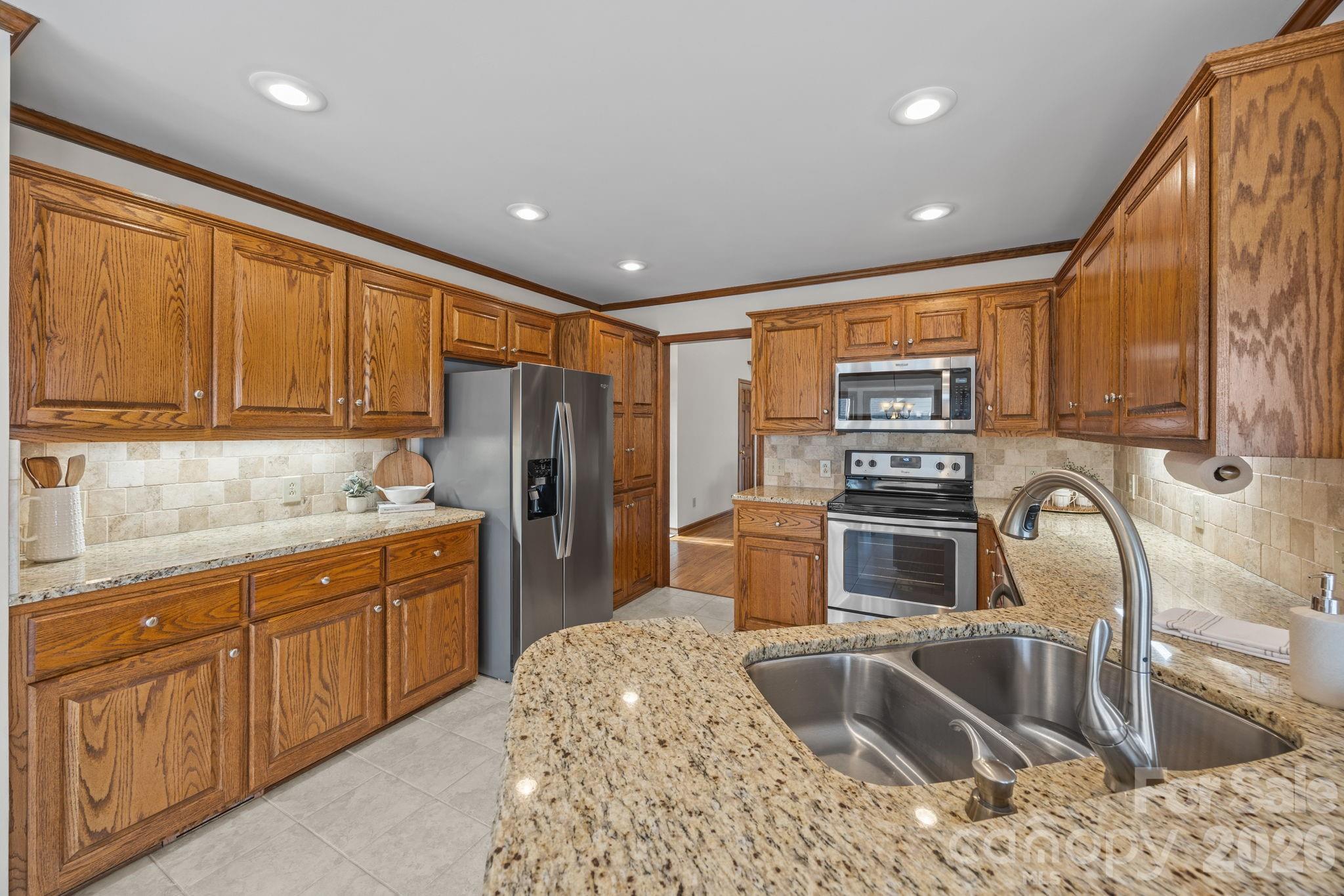 49449 River Run Road Albemarle, NC 28001 - Photo 13 of 45 a kitchen with stainless steel appliances granite countertop a sink stove and refrigerator