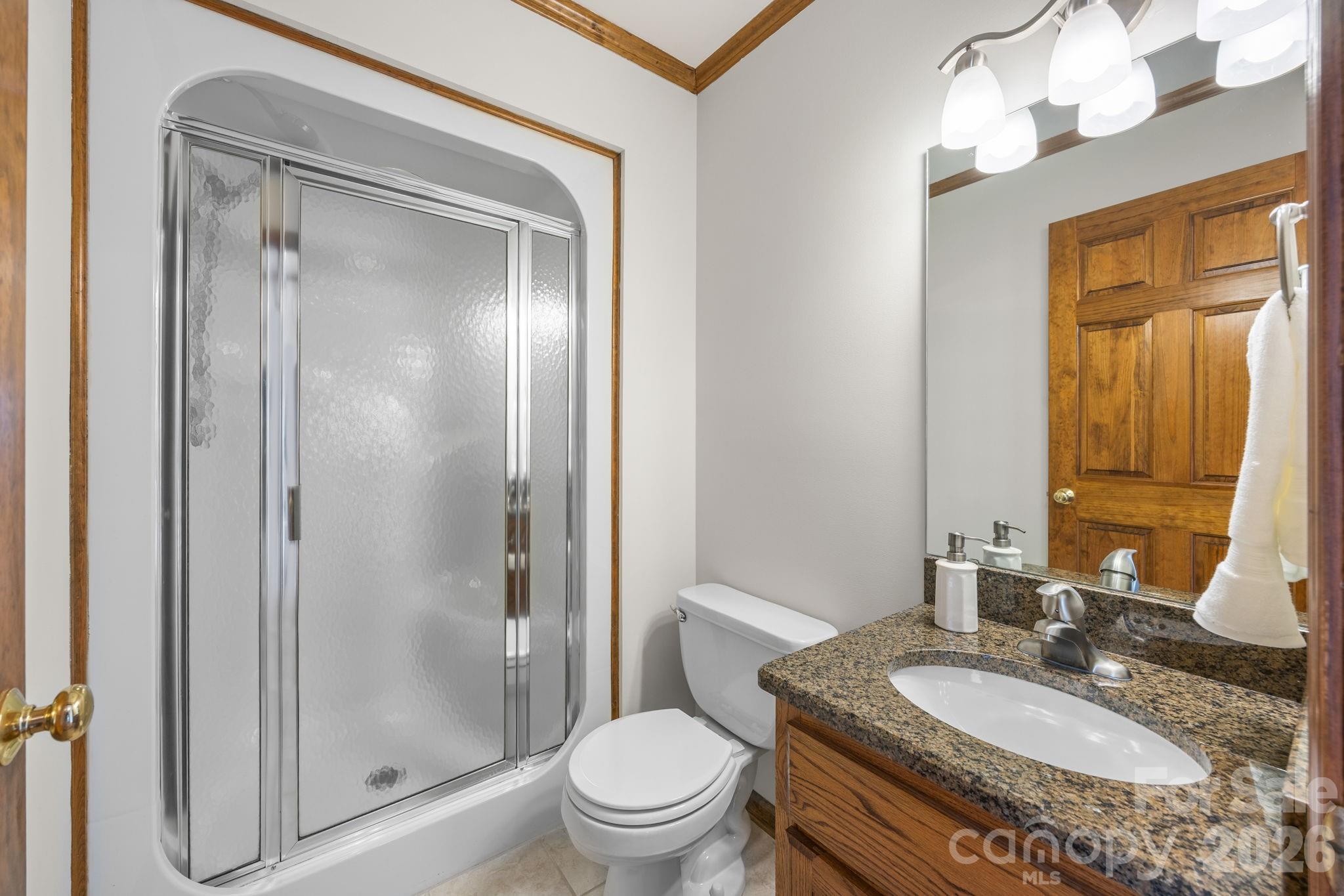 49449 River Run Road Albemarle, NC 28001 - Photo 22 of 45 a bathroom with a granite countertop sink toilet and shower