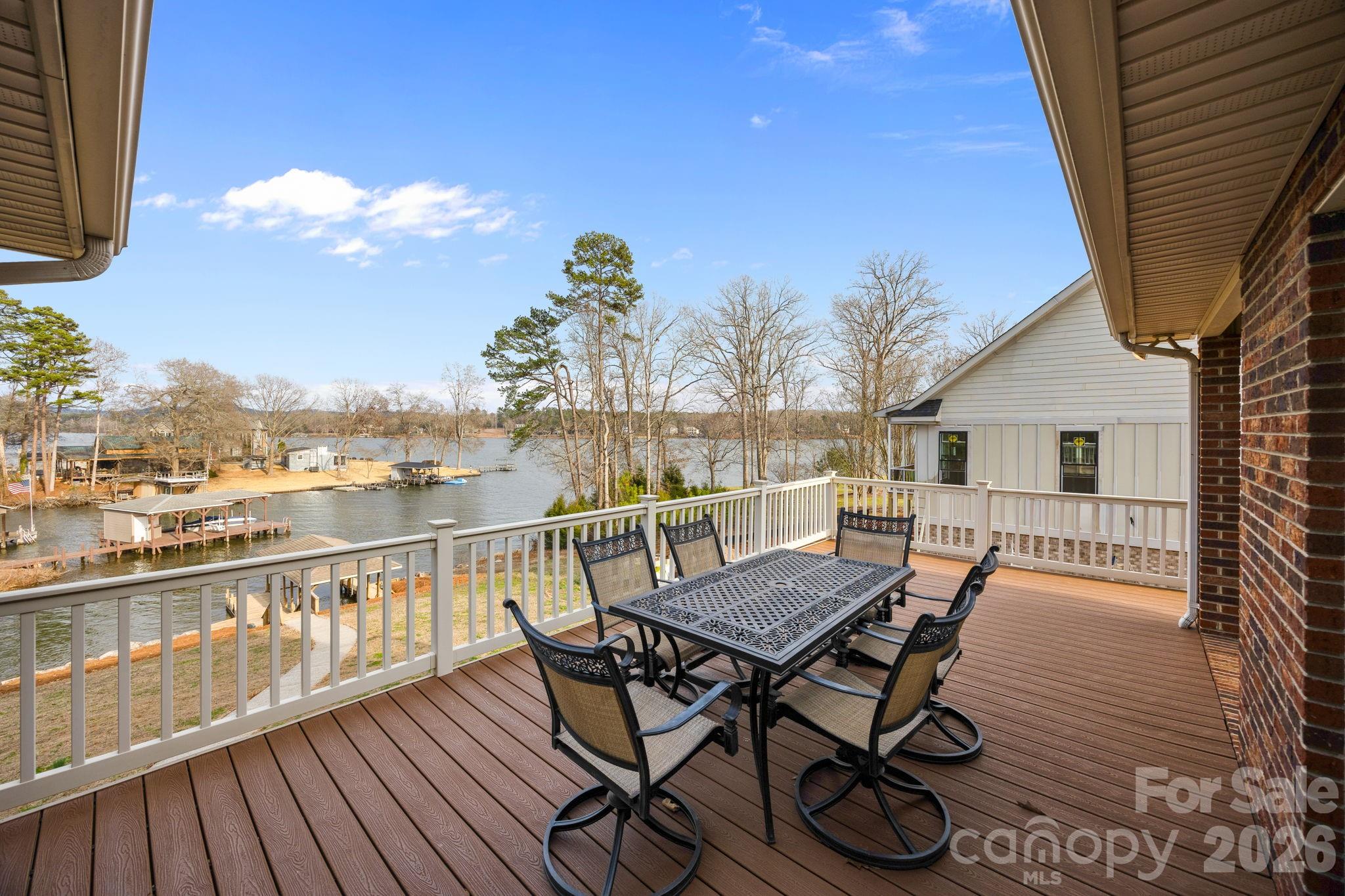 49449 River Run Road Albemarle, NC 28001 - Photo 26 of 45 a view of a roof deck with table and chairs a barbeque with wooden floor and fence