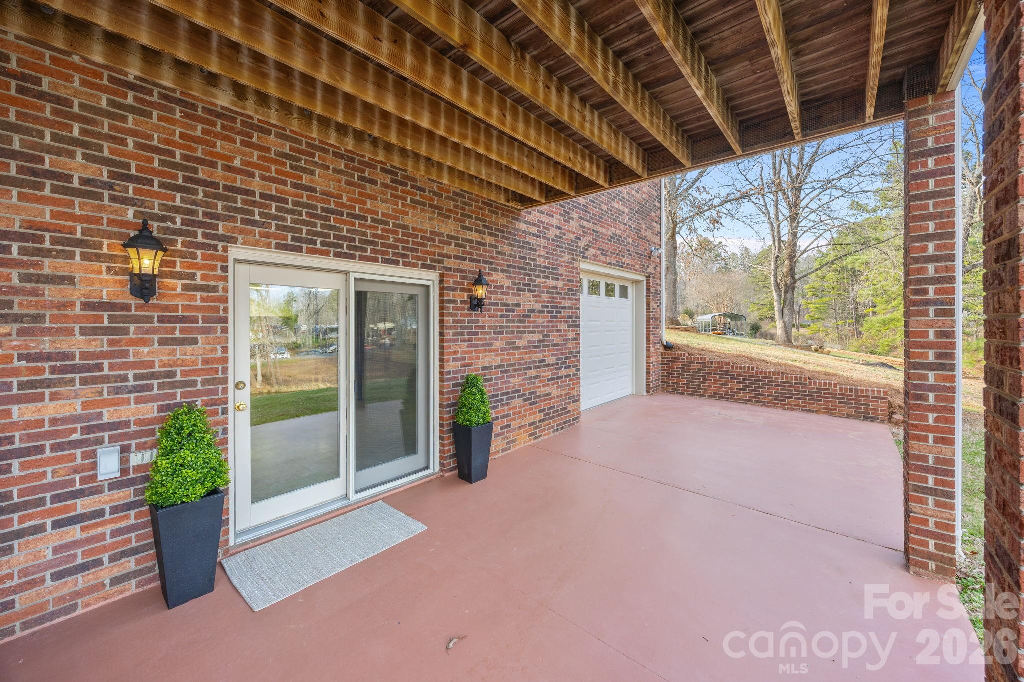 49449 River Run Road Albemarle, NC 28001 - Photo 29 of 45 a view of a porch with a table and chairs