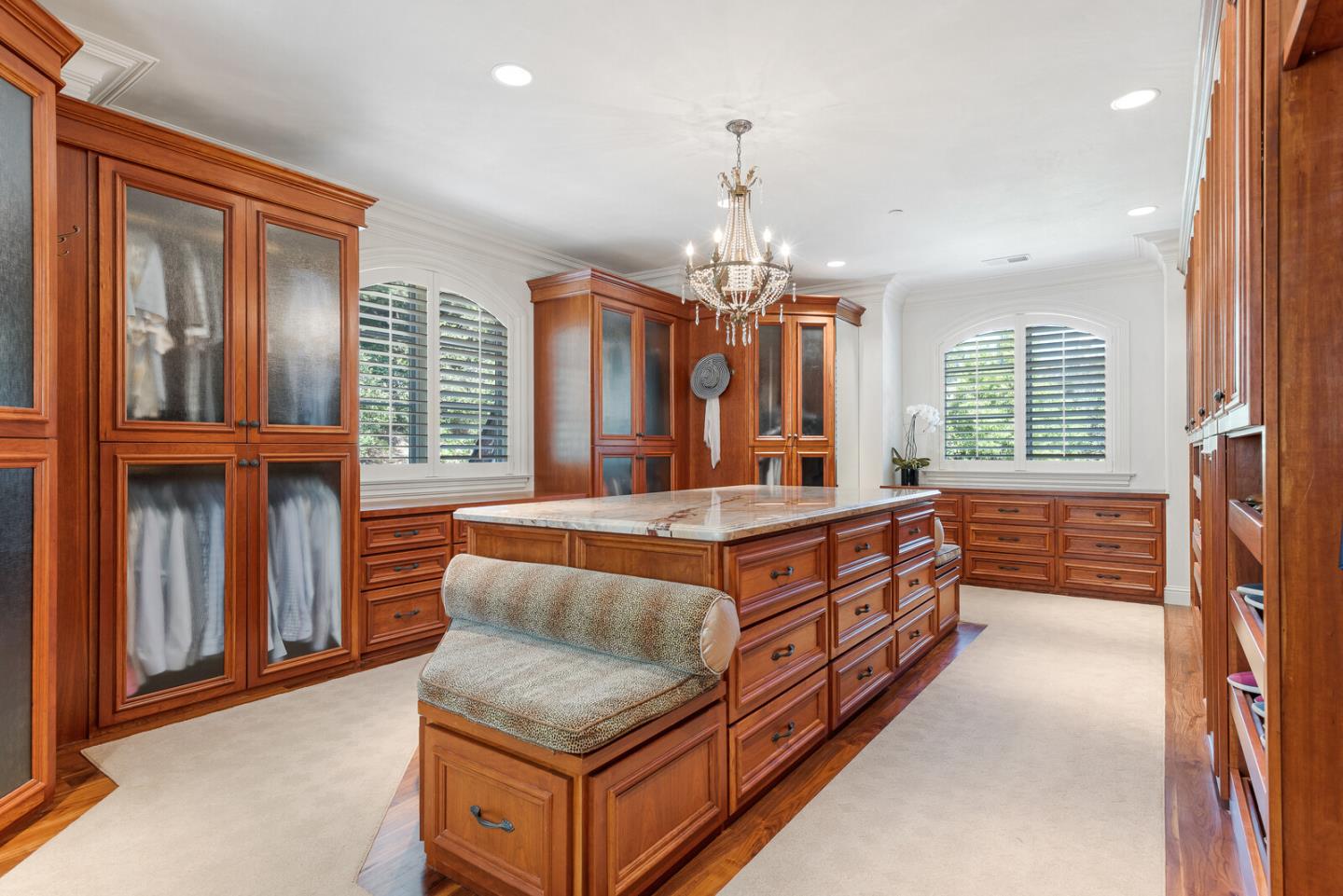 910 Link Road Hillsborough, CA 94010 - Photo 23 of 37 a large spacious bedroom with a large bed and a chandelier