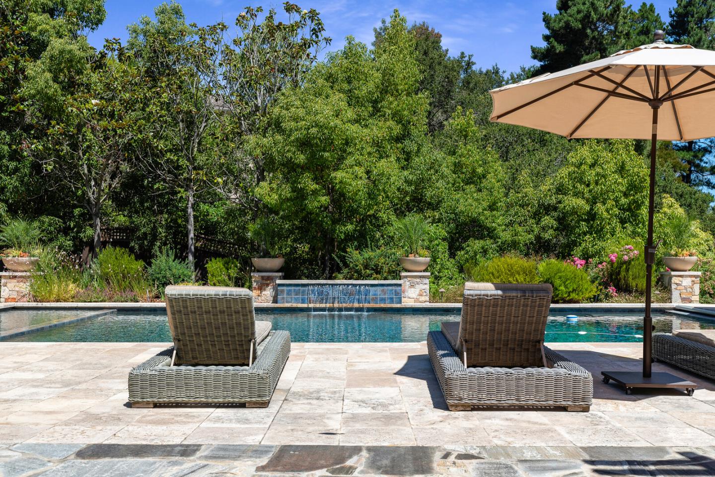 910 Link Road Hillsborough, CA 94010 - Photo 29 of 37 a view of a patio with couches table and chairs under an umbrella