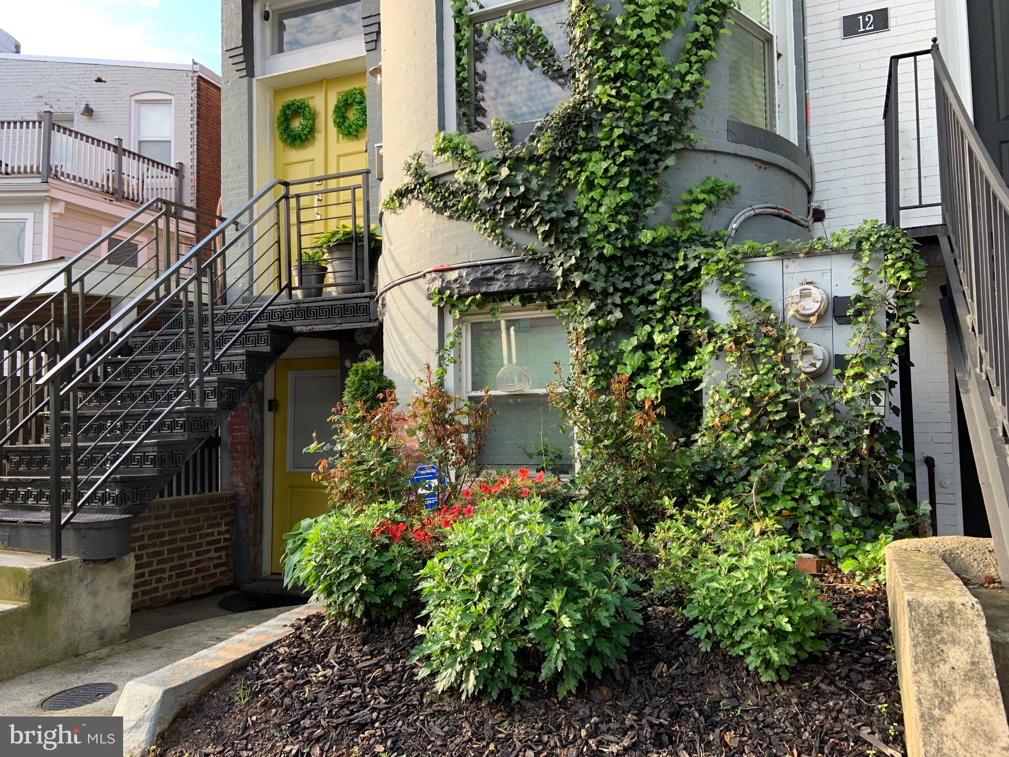 10 N Street Northwest, Unit STREET Washington, DC 20001 - Photo 1 of 11 a view of a house with a flower garden