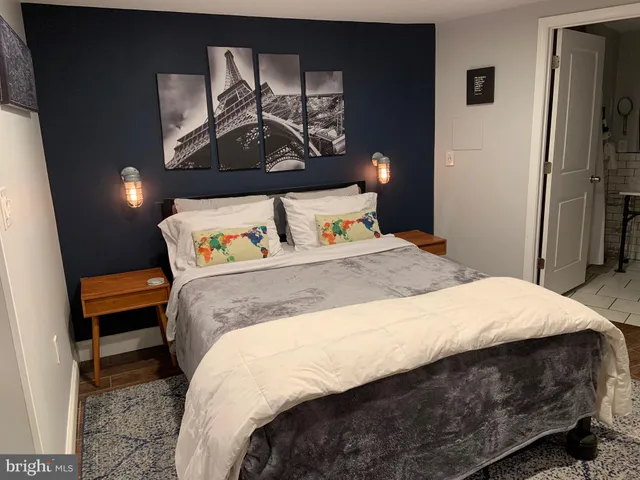 a bedroom with a bed and dresser