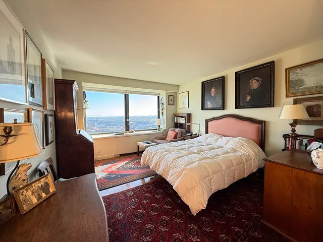 a bedroom with a large bed and a window