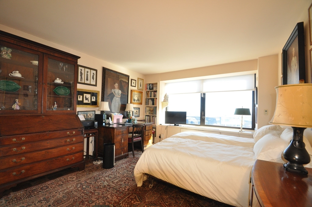 65 East India Row, Unit PHF Boston, MA 02110 - Photo 12 of 13 a bedroom with a bed and dresser with mirror