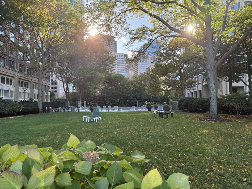 65 East India Row, Unit PHF Boston, MA 02110 - Photo 13 of 13 a backyard of a house with table and chairs