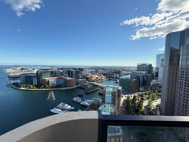 a view of a balcony with dining table and chairs
