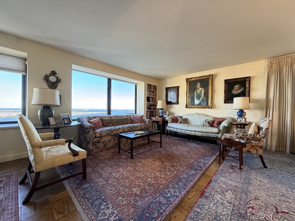 65 East India Row, Unit PHF Boston, MA 02110 - Photo 6 of 13 a living room with furniture a rug and a window