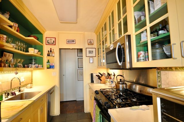 a kitchen with stainless steel appliances granite countertop a sink and a stove