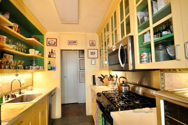 a kitchen with stainless steel appliances granite countertop a sink and a stove