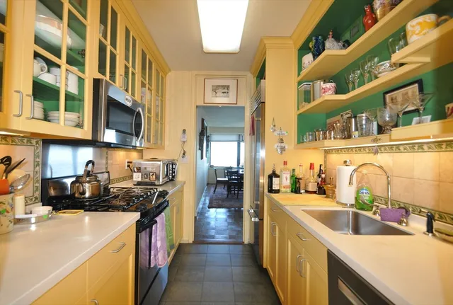 a kitchen with stainless steel appliances a sink and a counter top space