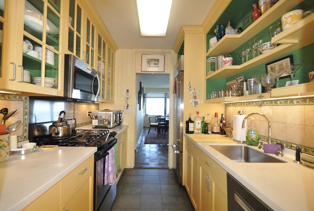 65 East India Row, Unit PHF Boston, MA 02110 - Photo 10 of 13 a kitchen with stainless steel appliances a sink and a counter top space
