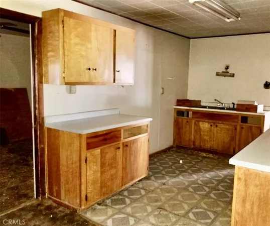 a kitchen with stainless steel appliances a stove a sink and a refrigerator