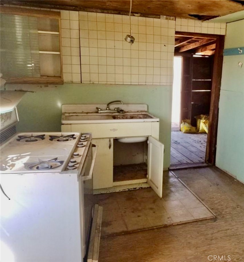 5151 Highway 395 Ridgecrest, CA 93555 - Photo 7 of 13 a stove top oven sitting inside of a kitchen