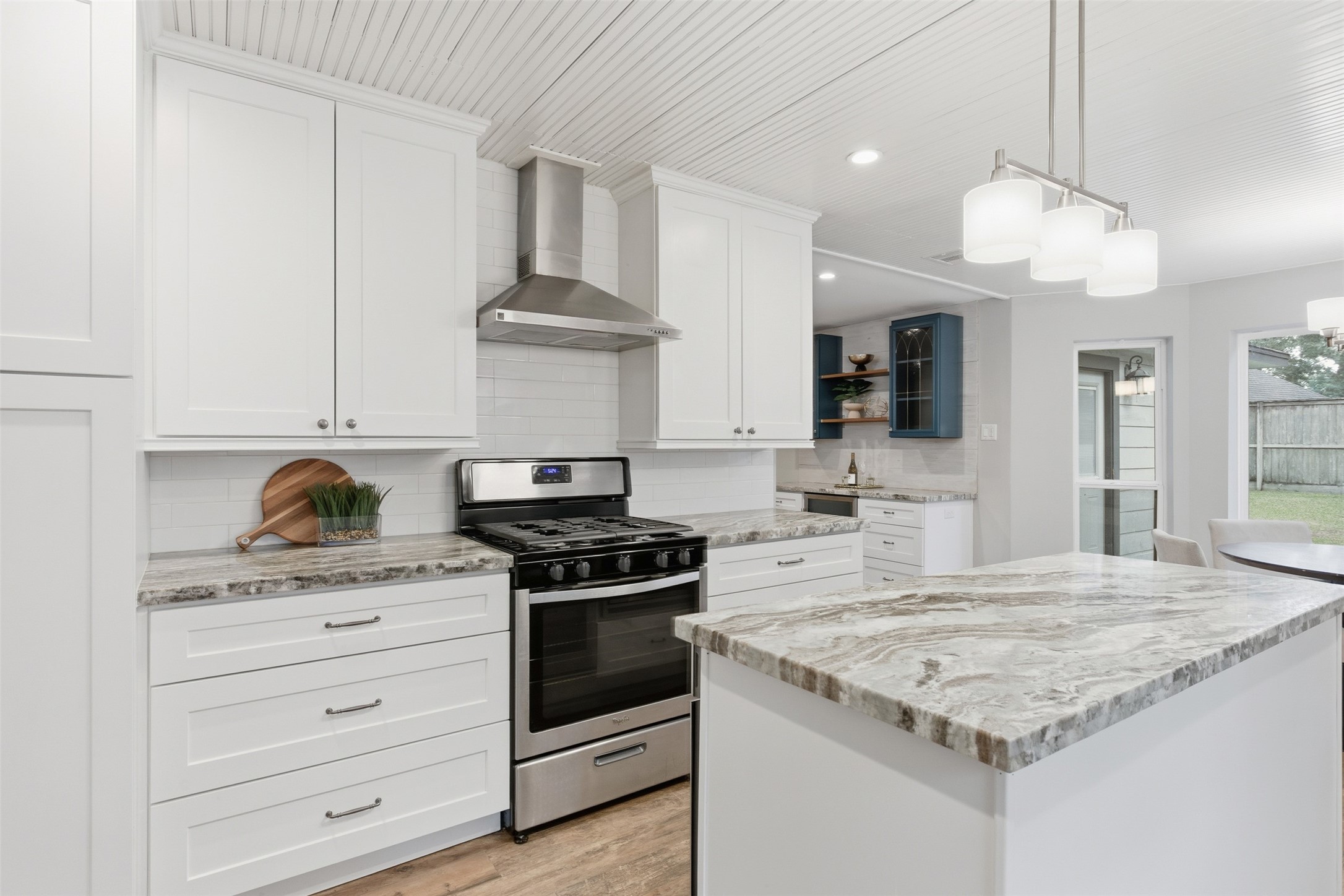 8107 Twining Oaks Lane Spring, TX 77379 - Photo 11 of 41 a kitchen with granite countertop stainless steel appliances a stove cabinets and wooden floor