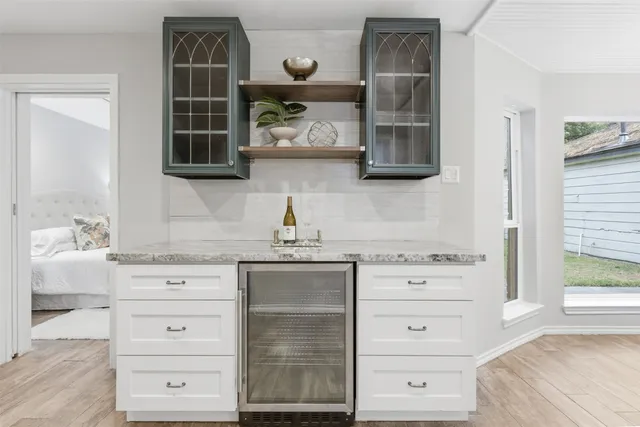 a kitchen with cabinets appliances and a window