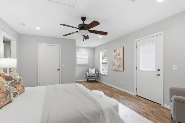 a bedroom with a large bed and a chandelier