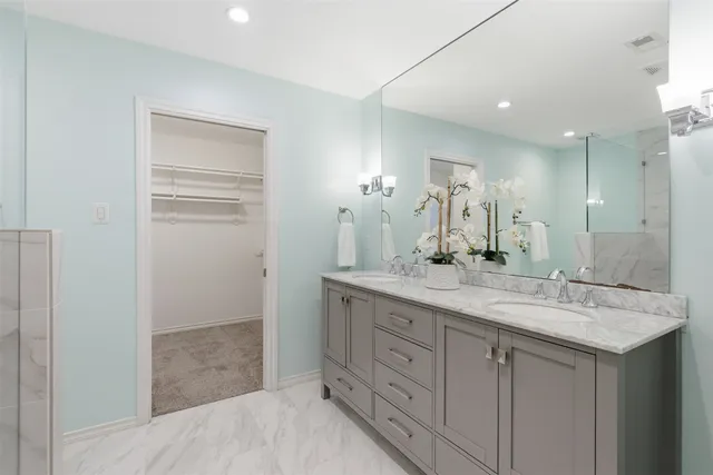 a bathroom with a granite countertop sink mirror and double