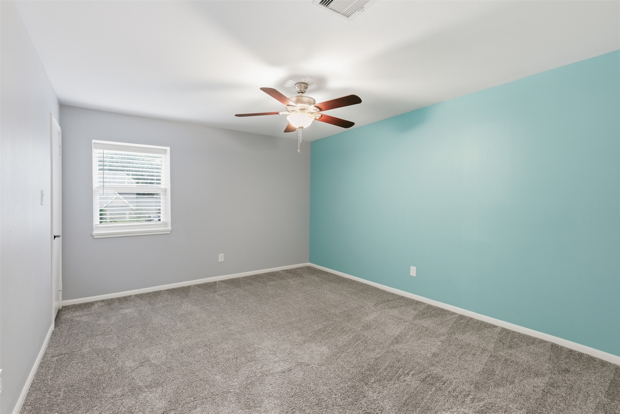 8107 Twining Oaks Lane Spring, TX 77379 - Photo 24 of 41 an empty room with a chandelier fan and windows