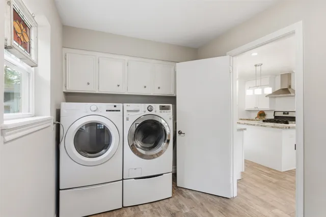 a utility room with sink dryer and washer