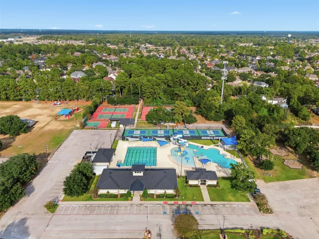 an aerial view of residential houses with outdoor space and street view