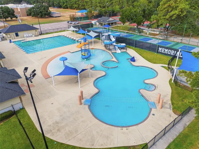 a view of a swimming pool with outdoor seating