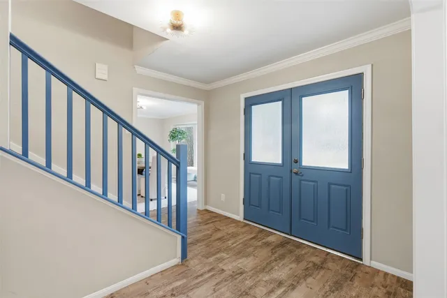 a view of an entryway with wooden floor