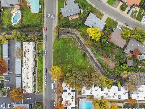 an aerial view of residential houses with outdoor space