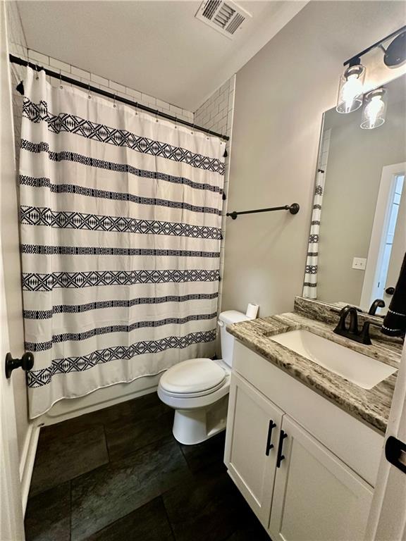 815 Poplar Street Monticello, GA 31064 - Photo 32 of 33 a bathroom with a granite countertop sink toilet and shower