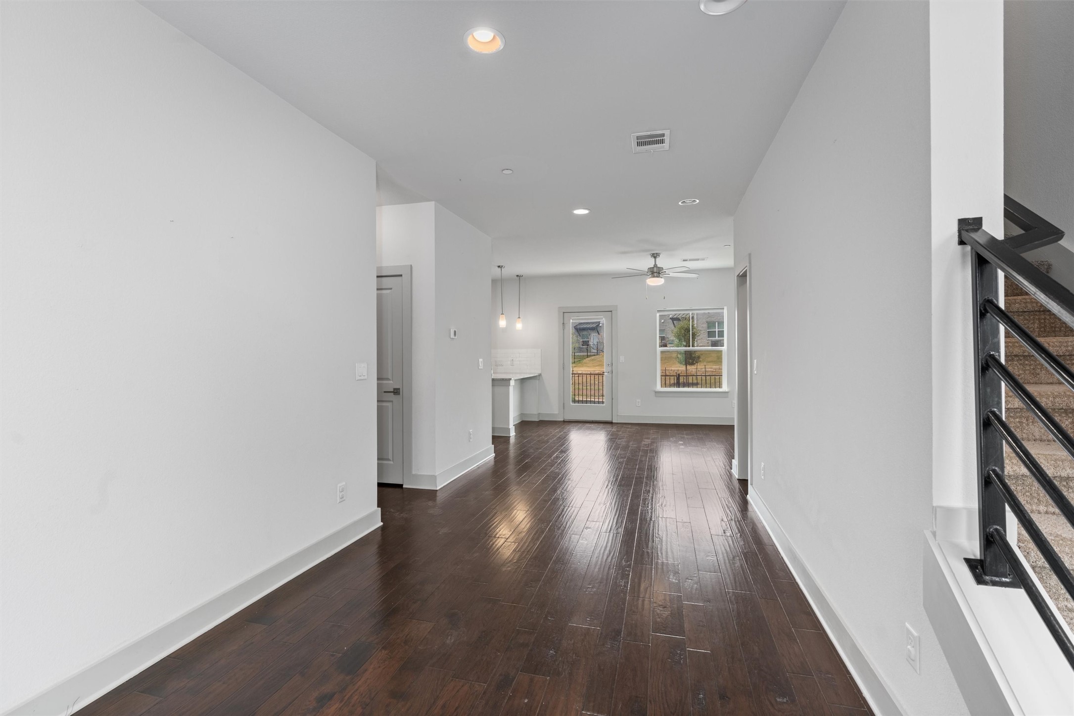 2057 Local Rebel Street, Unit 2057 Leander, TX 78641 - Photo 3 of 37 a view of an empty room with wooden floor and a window
