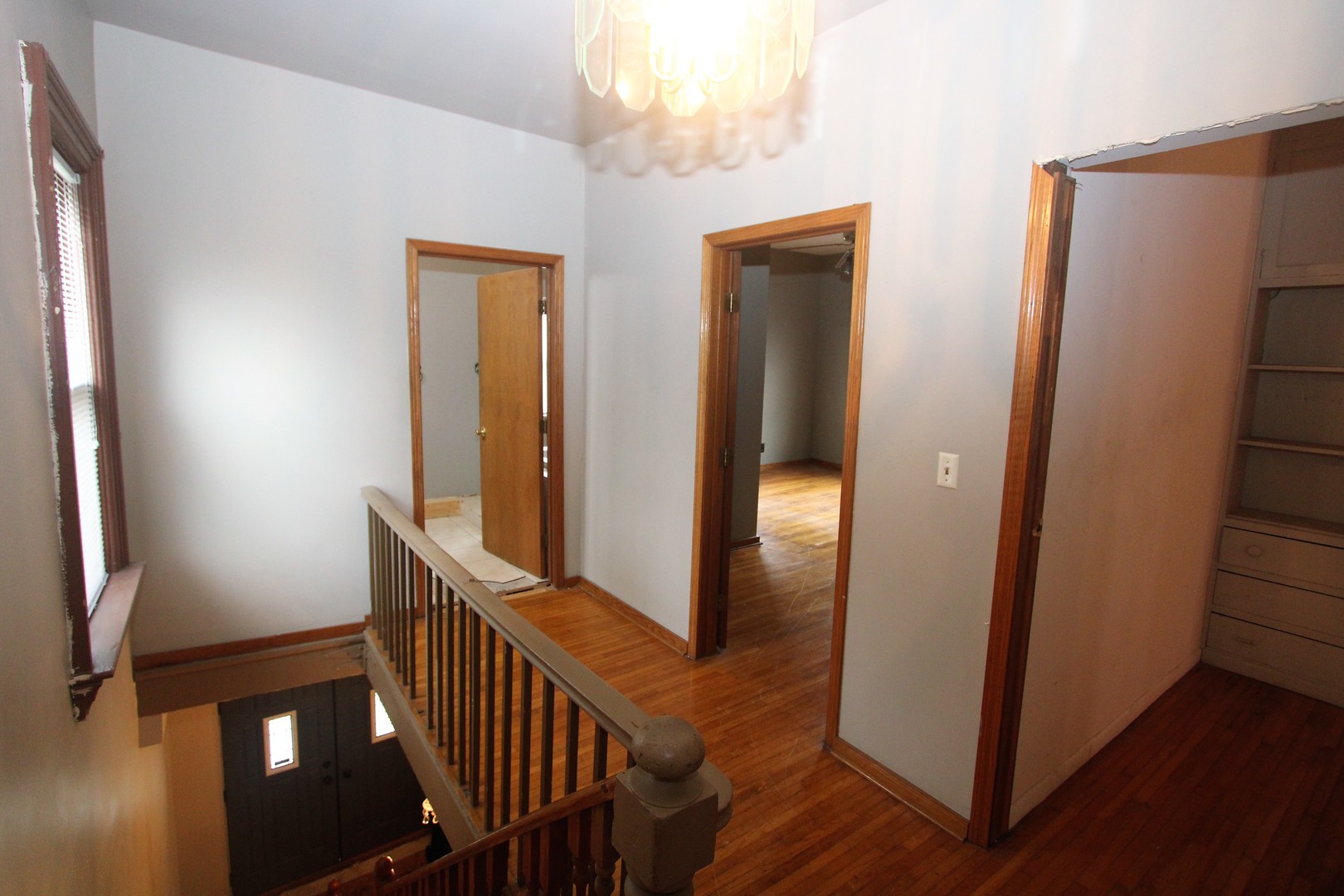 620 Oneida Street Joliet, IL 60435 - Photo 22 of 28 a view of a hallway with wooden floor and stairs