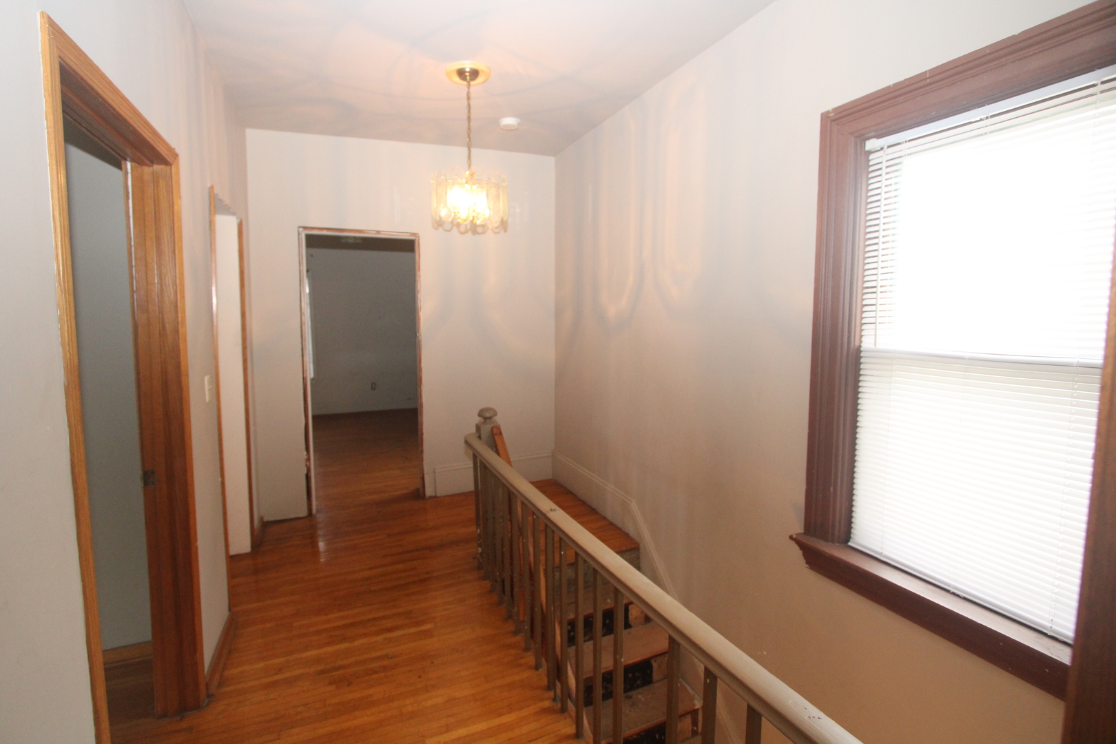 620 Oneida Street Joliet, IL 60435 - Photo 23 of 28 a view of a hallway with wooden floor and staircase