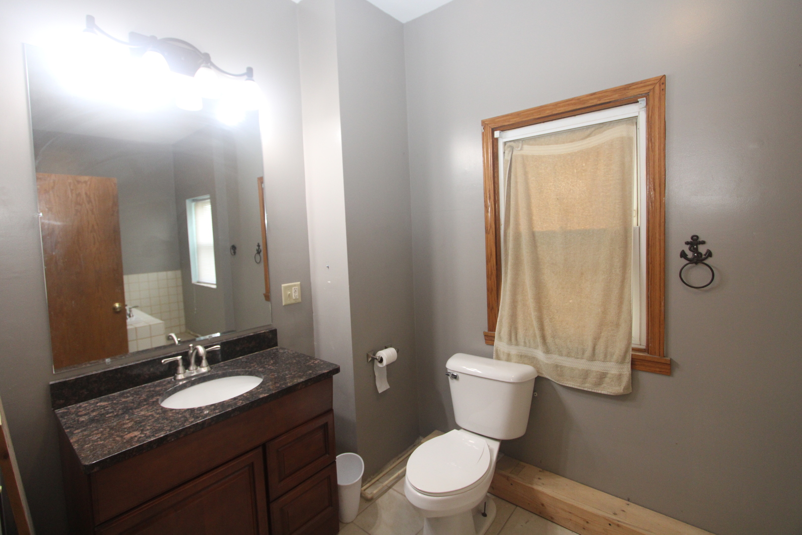 620 Oneida Street Joliet, IL 60435 - Photo 25 of 28 a bathroom with a granite countertop sink a toilet and a mirror