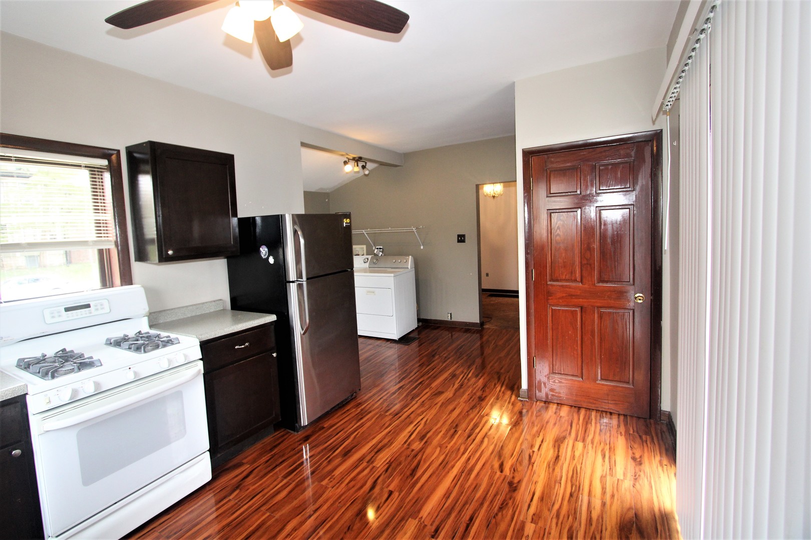 620 Oneida Street Joliet, IL 60435 - Photo 5 of 28 a kitchen with a refrigerator and a stove top oven