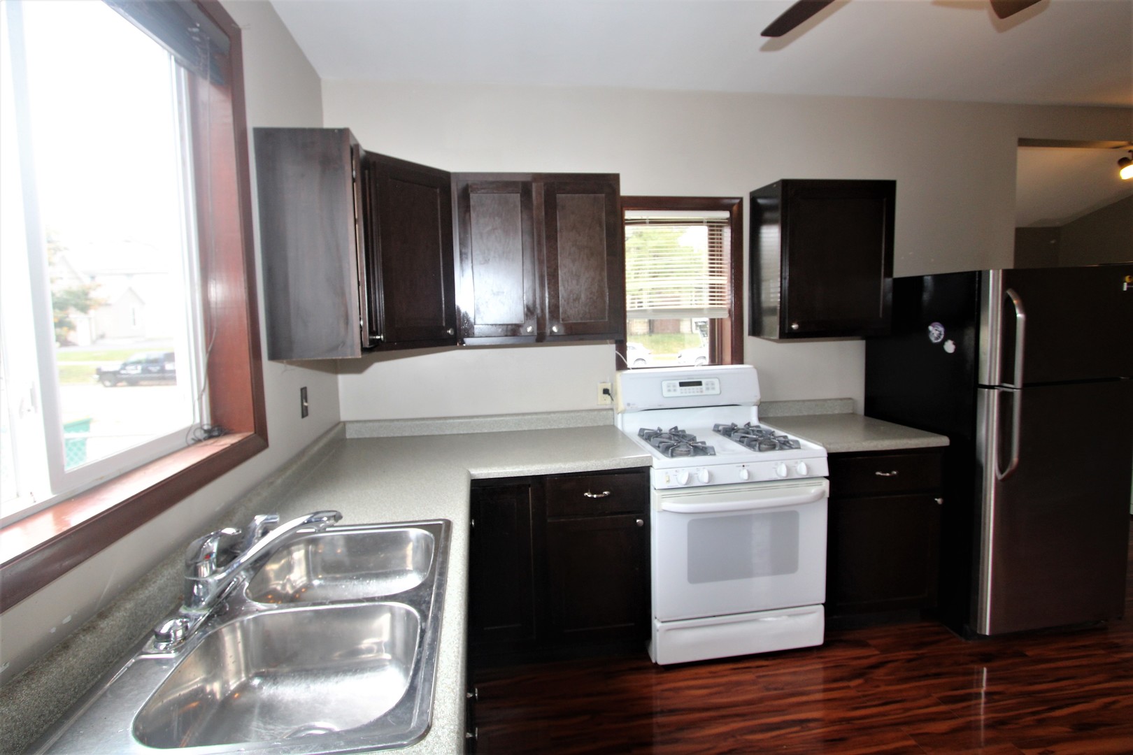 620 Oneida Street Joliet, IL 60435 - Photo 6 of 28 a kitchen with a sink and refrigerator