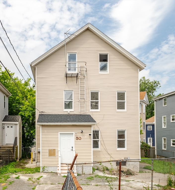 50 Tecumseh Street Fall River, MA 02721 - Photo 1 of 36 a view of a white house with large windows next to a road