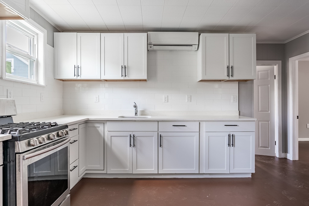 50 Tecumseh Street Fall River, MA 02721 - Photo 18 of 36 a kitchen with white cabinets and white appliances