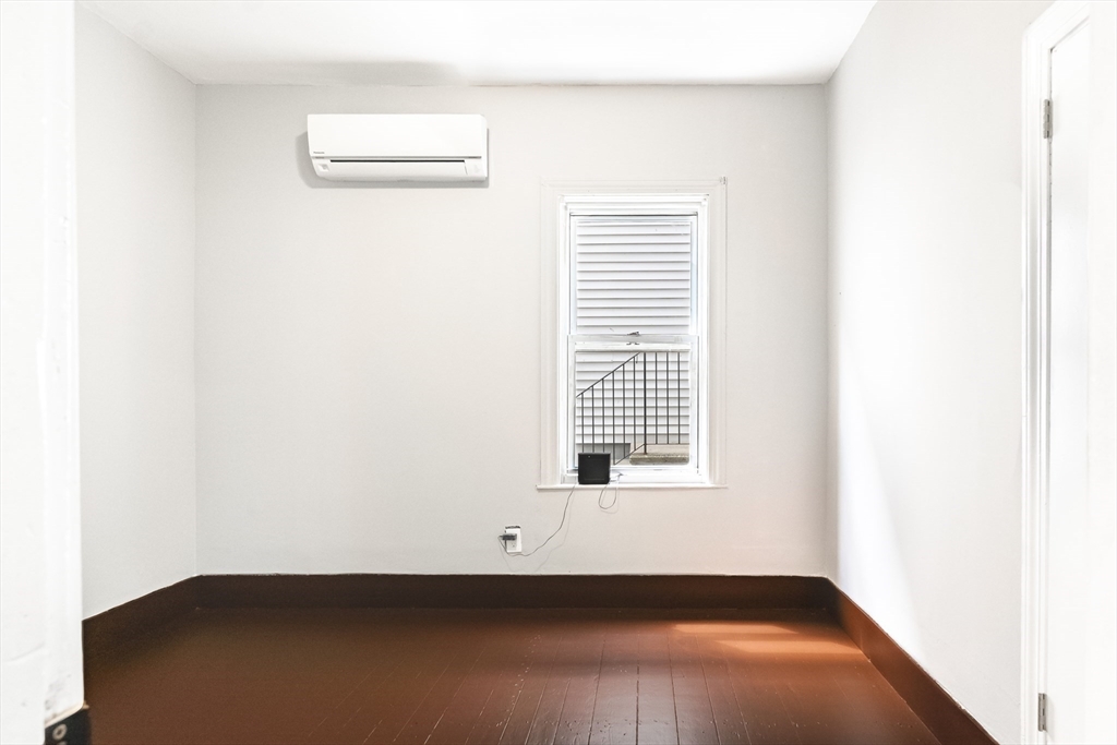 50 Tecumseh Street Fall River, MA 02721 - Photo 20 of 36 a view of an empty room with wooden floor and a window