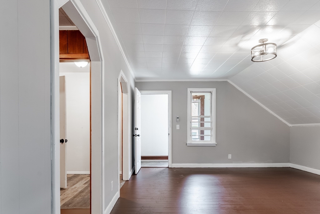 50 Tecumseh Street Fall River, MA 02721 - Photo 23 of 36 an empty room with wooden floor and windows
