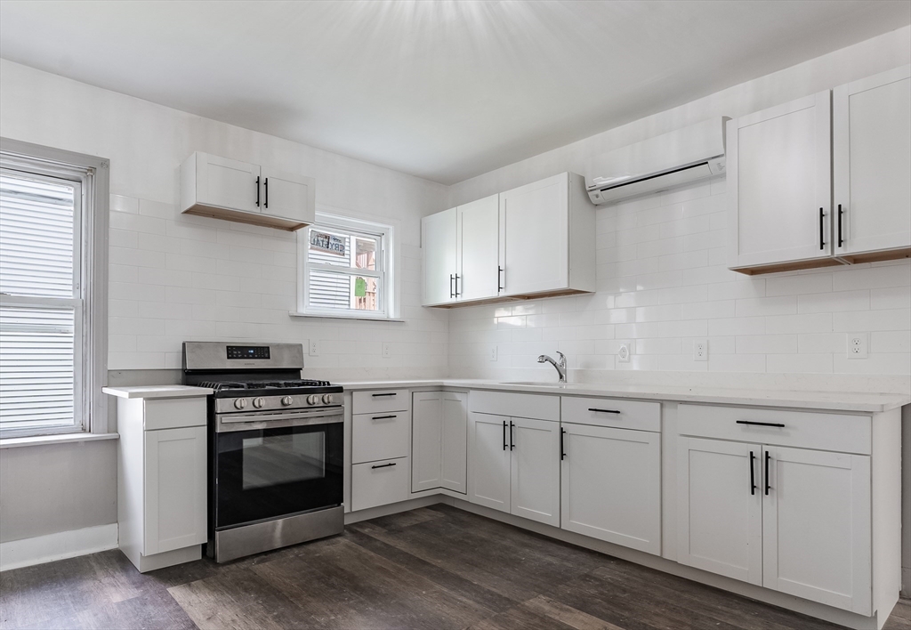 50 Tecumseh Street Fall River, MA 02721 - Photo 3 of 36 a kitchen with white cabinets stainless steel appliances and sink