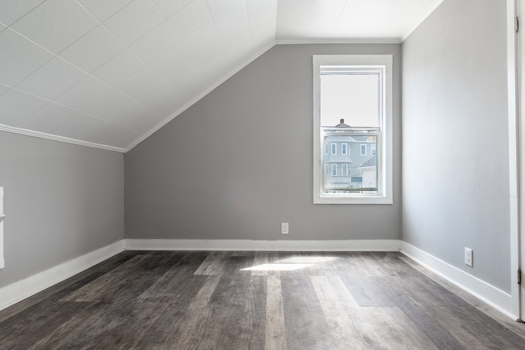 50 Tecumseh Street Fall River, MA 02721 - Photo 34 of 36 an empty room with wooden floor and windows