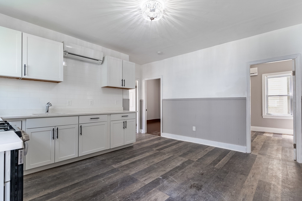50 Tecumseh Street Fall River, MA 02721 - Photo 4 of 36 a kitchen with granite countertop white cabinets and white appliances