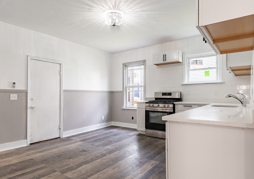 50 Tecumseh Street Fall River, MA 02721 - Photo 5 of 36 a kitchen with granite countertop a stove and a refrigerator