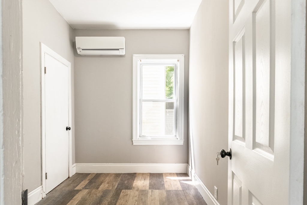 50 Tecumseh Street Fall River, MA 02721 - Photo 10 of 36 a view of a hallway with wooden floor and a cabinet